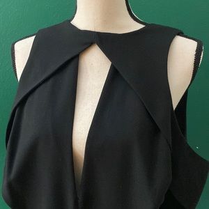 Black Asos straight leg Jumpsuit, low v neckline with side cutouts. Size 12